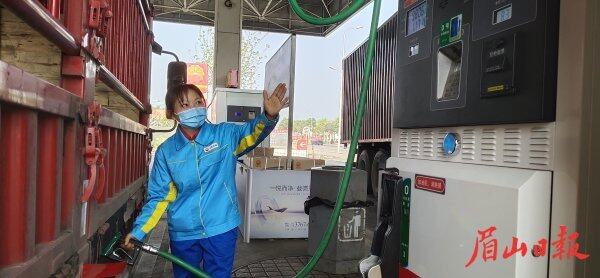  加油站工作人员为车辆加油。