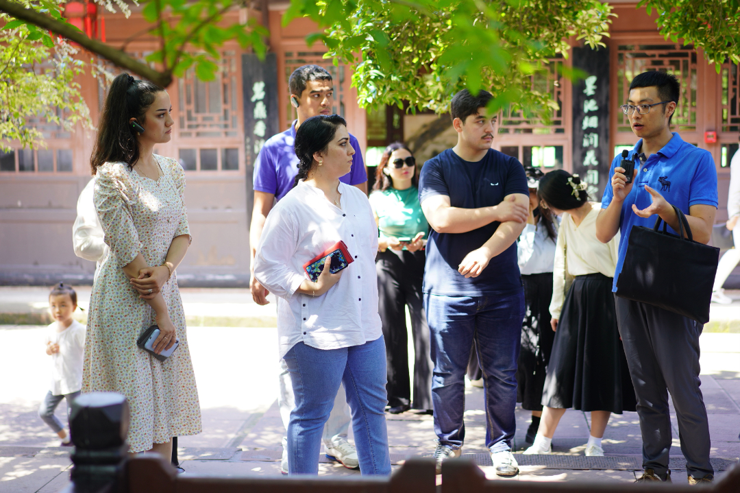 三苏祠内，青年外交官们正在认真聆听讲解。